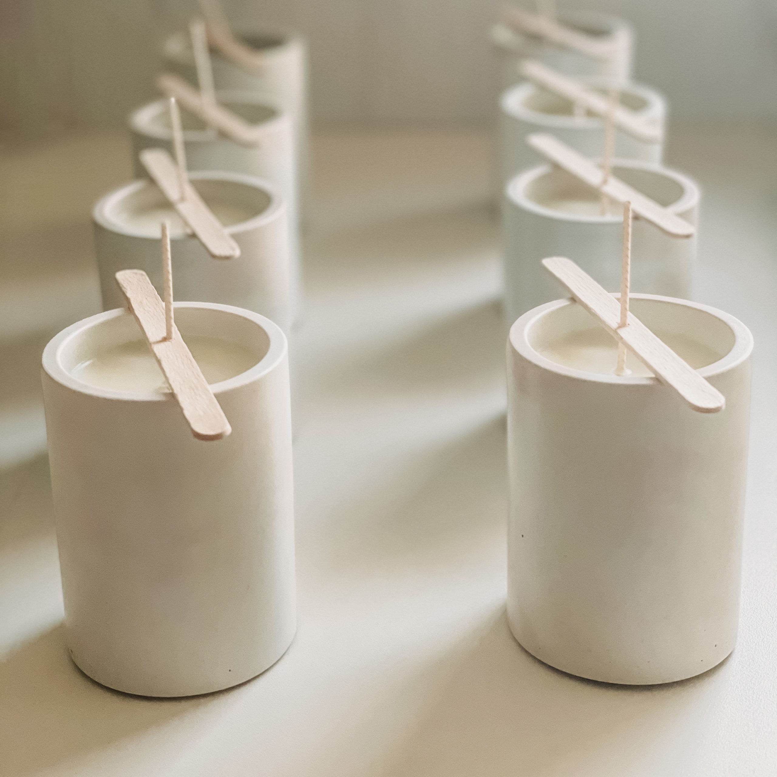 Lily White Co. candles curing in bespoke cement jars